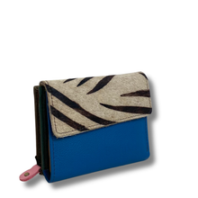 Blue wallet with zebra pattern flap on a white background