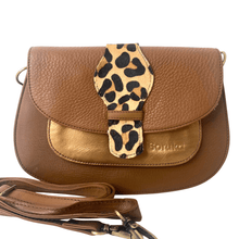 Brown leather handbag with a leopard print strap on a white background