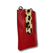 Red phone case with a leopard print strap on a white background