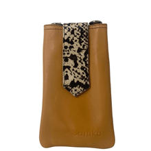 Brown leather pouch with a leopard print strap on a white background