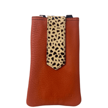 Brown leather phone case with a cheetah print strap on a white background