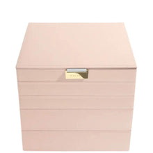 A light pink leather jewelry box with a gold-tone metal clasp on the front, set against a plain white background.