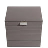 A taupe gray faux-leather jewelry organizer box with a silver metal pull handle labeled 'STACKER', shown on a plain white background.