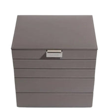 A taupe gray faux-leather jewelry organizer box with a silver metal pull handle labeled 'STACKER', shown on a plain white background.