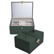 Green jewelry box with open lid showing jewelry inside on a white background