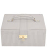 A light gray faux leather jewelry box with a top handle, vertical ribbed texture, and a gold-tone padlock clasp on a white background.