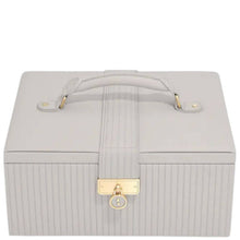 A light gray faux leather jewelry box with a top handle, vertical ribbed texture, and a gold-tone padlock clasp on a white background.