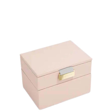 A light pink double-tier jewelry box with a gold-tone clasp and a silver-tone accent, shown on a plain white background.