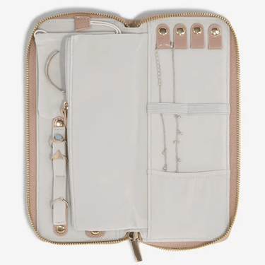 Open beige travel organizer with compartments on a white background