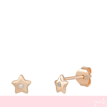 Rose gold star-shaped earrings with clear gemstones on a white background