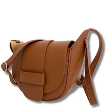 Brown leather saddle bag on a white background