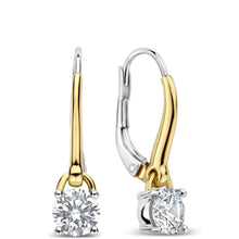 A pair of leverback earrings with round-cut clear gemstones in yellow gold and silver-tone settings, shown on a plain white background.