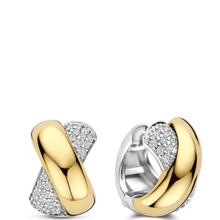 Gold and silver hoop earrings with embedded diamonds on a white background