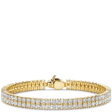 Gold bracelet with clear stones on a white background