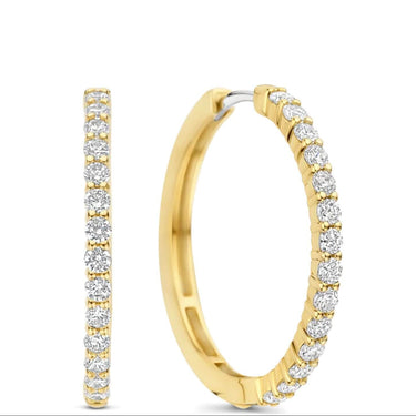 A pair of gold hoop earrings with a single row of round-cut clear gemstones along the front, shown on a plain white background.