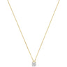 A delicate yellow gold chain necklace with a small cushion-cut clear gemstone pendant, displayed against a solid white background.