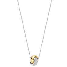 Necklace with a gold and silver pendant on a white background