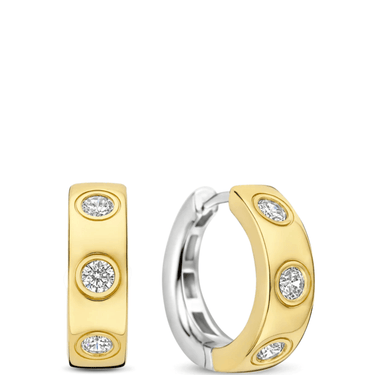 Gold and silver hoop earrings with embedded diamonds on a white background