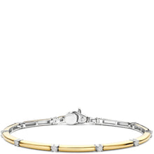 A two-tone metal bracelet featuring a polished yellow gold tube accented by small round clear stones, set in a silver-toned bangle. The image is shot on a plain white background with the bracelet positioned in the lower half of the frame.