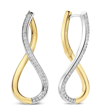 A pair of infinity-shaped hoop earrings in yellow gold and white gold, with pavé-set clear stones along the white gold sections, shown on a plain white background.