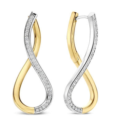 A pair of infinity-shaped hoop earrings in yellow gold and white gold, with pavé-set clear stones along the white gold sections, shown on a plain white background.