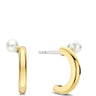 A pair of gold huggie hoop earrings with a small white pearl stud on each earring, shown against a plain white background.
