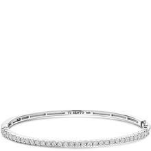 Silver bracelet with clear stones on a white background