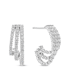 Pair of silver hoop earrings with clear gemstones on a white background