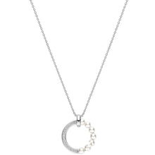 A silver necklace featuring a crescent moon pendant adorned with small white pearls and a pavé-set clear stone, shown against a plain white background.