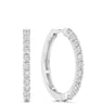 A pair of silver hoop earrings with a single row of round-cut clear gemstones along the front, shown on a plain white background.