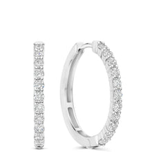 A pair of silver hoop earrings with a single row of round-cut clear gemstones along the front, shown on a plain white background.