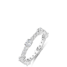 A silver diamond eternity band ring shown at an angle on a clean white background.