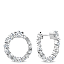 Pair of silver hoop earrings with clear gemstones on a white background