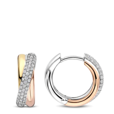 Pair of hoop earrings in gold and silver on a white background