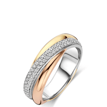 Three-toned ring with gold, rose gold, and silver bands on a white background