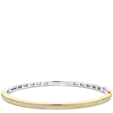 Gold and silver bracelet with clear stones on a white background