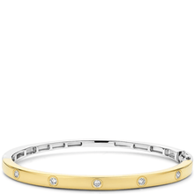 Gold and silver bracelet with small diamonds on a white background