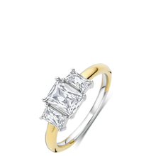 Two-tone gold ring with a diamond on a white background