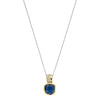 A two-tone gold and silver necklace featuring a cushion-cut dark blue gemstone pendant, displayed against a solid white background.
