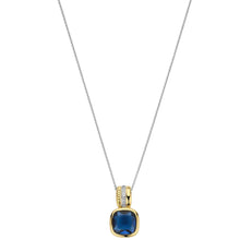 A two-tone gold and silver necklace featuring a cushion-cut dark blue gemstone pendant, displayed against a solid white background.