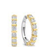 A pair of gold and silver huggie hoop earrings with round-cut clear gemstones, shown on a plain white background.