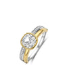 A two-tone yellow gold and silver ring featuring a cushion-cut clear center stone and a pavé-set silver band with a yellow gold accent.