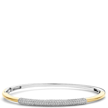 A two-tone bangle bracelet featuring a polished yellow gold outer band and a pavé-set silver-toned center section with clear stones, shown against a plain white background.
