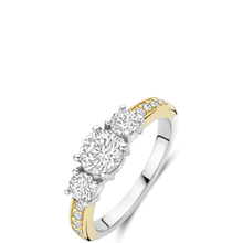 Two-tone gold and silver ring with three diamonds on a white background