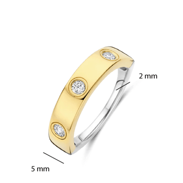 Gold and silver ring with three diamonds on a white background
