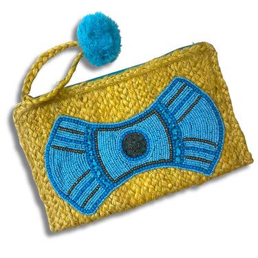 Yellow woven clutch with blue beaded bow design and blue pom-pom on a white background