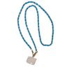 Necklace with blue beads and a silver pendant on a white background