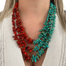 Red and turquoise beaded necklaces worn by a person against a white background