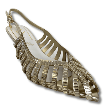 Gold high-heeled sandal on a white background