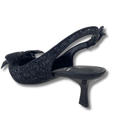 Black glittery high-heeled shoe with a bow on a white background